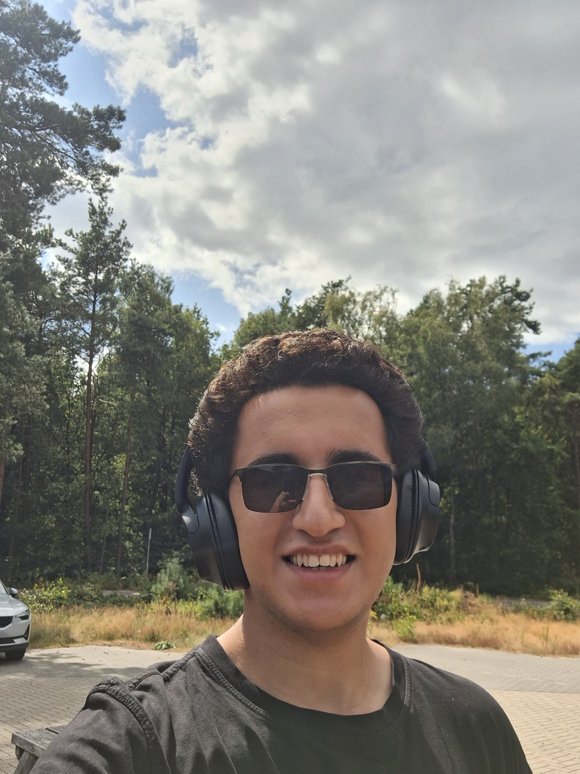 Kiarash smiling during a hike